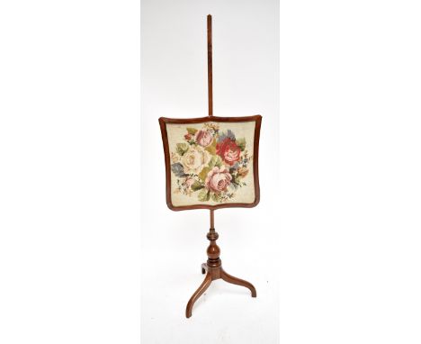 A Victorian mahogany fire screen with needle work panel and three square section outswept supports, height 146cm.