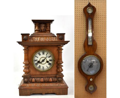A 19th century rosewood wheel barometer, length 94cm, also a late 19th/early 20th century carved walnut mantel clock, the cir
