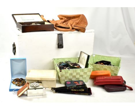 A white painted trunk containing a large quantity of costume jewellery including beads and various necklaces.