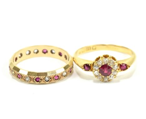 An Edwardian 18ct yellow gold diamond and ruby dress ring set with further rubies to shoulders, size M, and a 9ct eternity ri