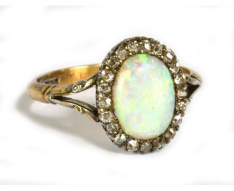 A yellow metal opal and diamond oval ring, the opal approx 9 x 6mm, size N, approx 3.3g.