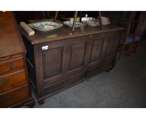 A George III oak four panel mule chest of traditional arrangement, with moulded top over four fielded panels and two base dra
