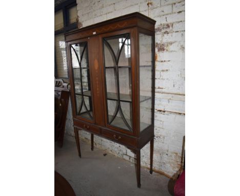 An Edwardian inlaid mahogany display cabinet, having ribbon and swag inlaid frieze, over pendant inlaid central panel flanked