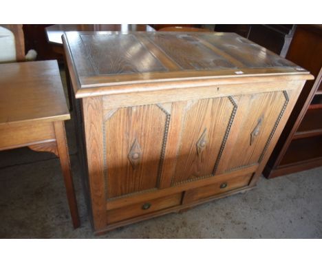 A 1940s oak three panel mule chest, having beaded and moulded decoration, the base with two drawers. 85CM. X. 105CM.