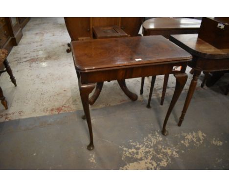 A 1920s figured walnut fold over card table, with typical swivel action and cabrial type supports 73CM. X. 75CM.