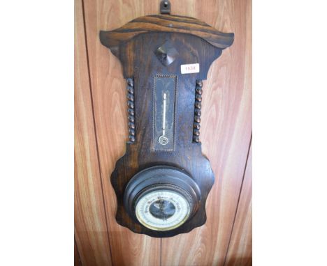 A 1940s oak barometer, damage to thermometer scale. 56CM.