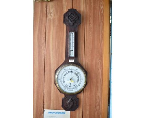 The 20th century aneroid barometer, having rudimentary carving and enameled dial. 76CM