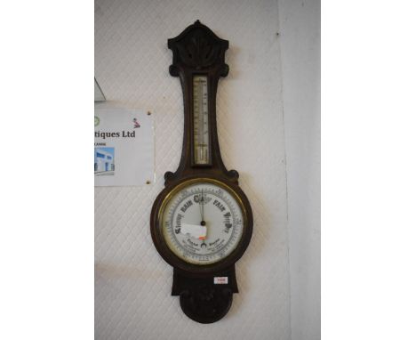 An Edwatdian Stipple carved oak barometer of traditional design.