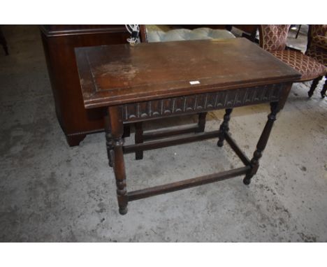 A Victorian oak foldover card table with swivel action and nulled frieze over turned supports,  76CM. X92CM.