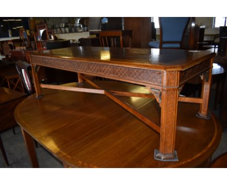 A Reproduction elm and mahogany rectangular coffee table, the canted top with quarter veneered central panel above a moulded 