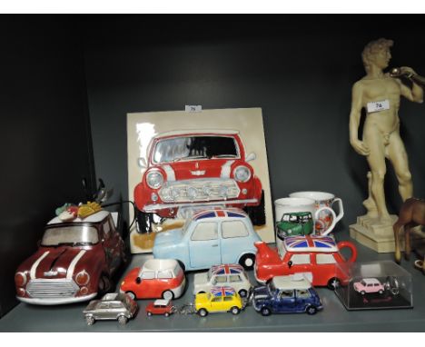 A selection of vintage Mini Cooper car models trinkets and ceramic tile