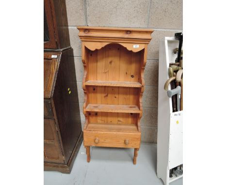 A modern pine wall shelf with drawer