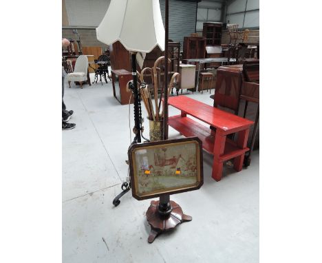 A 19th century rosewood pole screen having later needlework tapestry inset depicting a cottage on adjustable column and trefo
