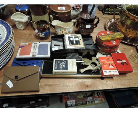 A selection of vintage playing cards and an automatic card shuffler