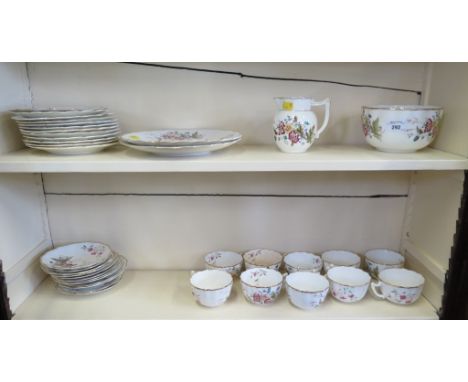 An Edwardian part tea service, with printed and enamelled floral decoration, unmarked, including two bread plates, 38 pieces