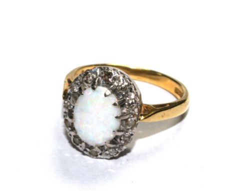 An 18 carat gold cluster ring, set with opal and diamond