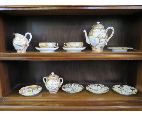 A Japanese egg shell porcelain tea service decorated with cranes and rushes, in a spotted pink ground