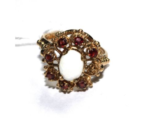 A garnet and opal ring set in 9 carat gold