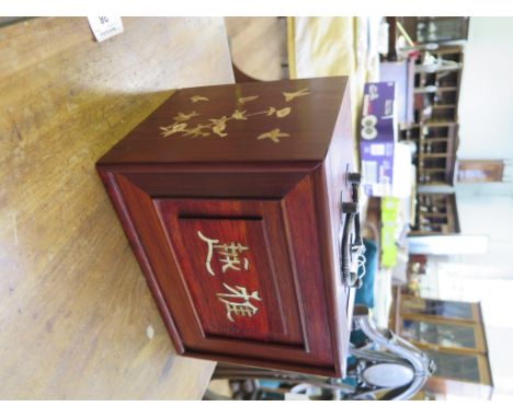 Chinese rosewood box inlaid with mother of pearl decoration and containing six slide out trays with a hidden front slide open