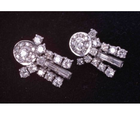 A pair of ornate white gold (not hallmarked or tested) drop earrings set with a mixture of round brilliant cut diamonds and b