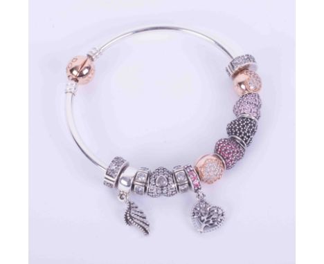 Silver Pandora bangle with a rose gold plated clasp and twelve various crystal encrusted beads and spacers of different desig