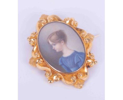 A yellow gold (not hallmarked or tested) ornate portrait miniature brooch of a girl in a blue dress, letter stamped JL, appro