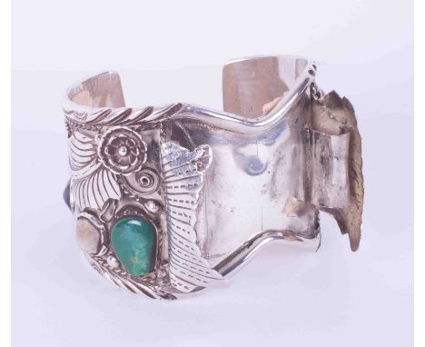 A silver ornate engraved Navajo cuff bangle signed L. Elthe set with gemstones including turquoise and amethyst, 98.80gm, 5cm