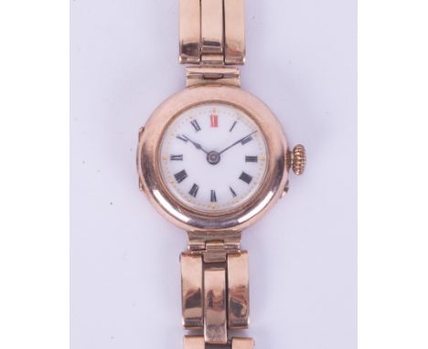 A ladies vintage 9ct gold wristwatch and bracelet, the enamel dial with red twelve, roman numerals, running when wound. Condi