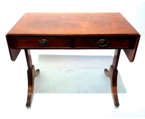 A Mahogany Sofa Table, the drop-flap top above two frieze drawers with oval brass handles raised upon twin end supports with 