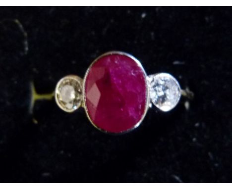 An 18ct. Yellow Gold Ruby and Diamond Ring, set with a central oval ruby flanked by diamonds within a pierced setting, approx