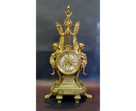 A 19th Century French Large Mantle Clock with torch and quiver surmount flanked by scrolled putti, the brass dial with enamel