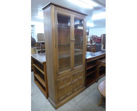 An Ercol Golden Dawn elm display cabinet 