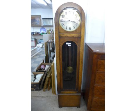 A 1930's oak triple weight longcase clock 