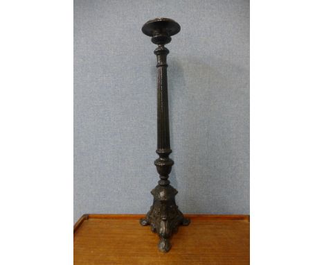 A large early 20th Century French cast iron candlestick 