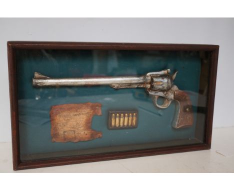 Shadow box with model revolver, bullets & reciept 