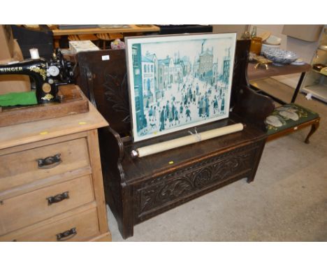 A carved oak monks bench