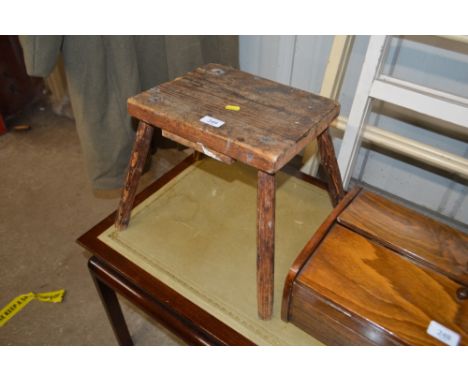 A rustic pine four legged stool