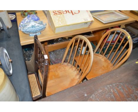 A spindle back and cane seated bedroom chair; and a pair of Ercol elm seated kitchen chairs 