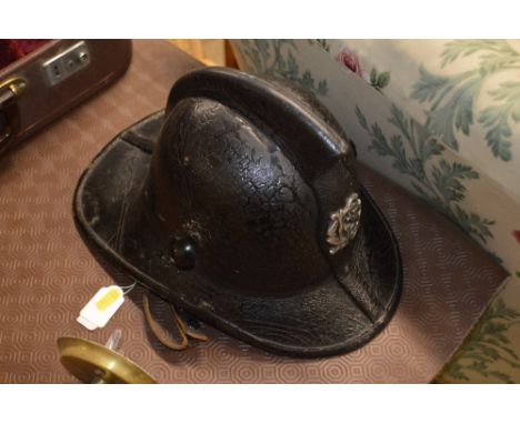 A vintage fireman's helmet, possibly Scottish