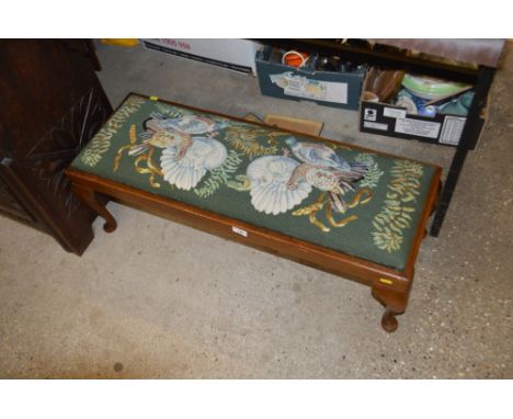 A mahogany framed oblong stool with needlework drop in seat