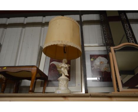 A table lamp decorated with cherubs