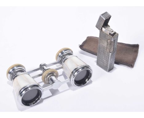 A pair of early 20th Century mother of Pearl opera glasses
Of typical form, mother of Pearl applied panels in a chromed frame