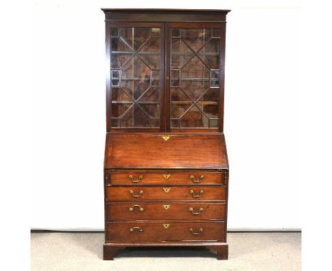 George III mahogany bureau bookcase, the upper section with moulded cornice, astragal glazed doors enclosing shelves, the bas
