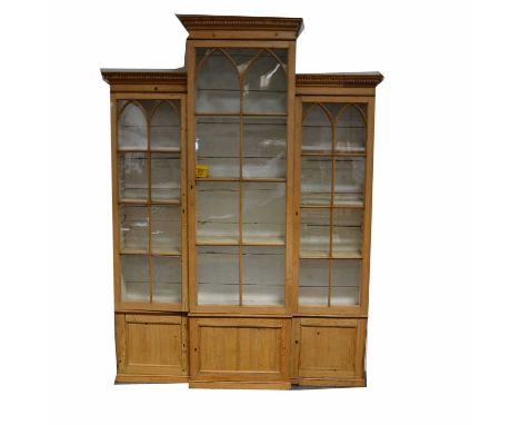 Pine breakfront bookcase, dentil and cavetto cornice, lancet glazed doors and cupboards below, width 175cm, depth 38cm, heigh