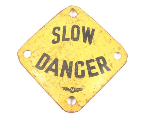 Yellow and black enamel warning sign 'SLOW DANGER', above a logo with 'M' between wings, 49cm wide.