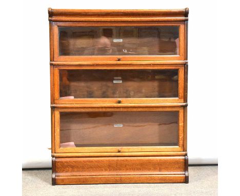 An oak three section Globe Wernicke sectional bookcase, plinth base, width 87cm, depth 32cm, height 111cm.Condition report:Th