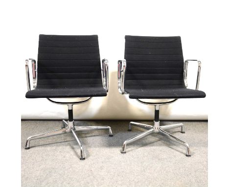 Pair of office chairs by Charles Eames for Vitra, model EA108, chromed frames with black fabric upholstery, applied labels wi