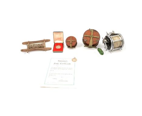 Vintage fishing rod box, canvas lined, leather strapping, 149cm; two mahogany and brass star-back reels, a silver commemorati