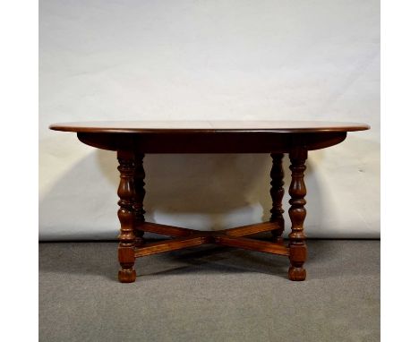 Ercol elm table and chairs, the table with oval extending top, turned legs joined by X stratcher, 162x107cm, (with additional