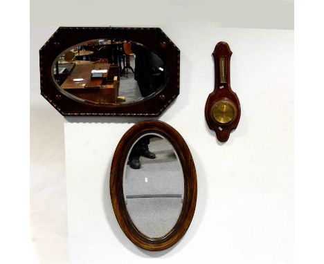 Oak wall mirror, oval bevelled plate; a simulated wood oval mirror; and a wall barometer.Qty: 3Condition report:Tarnishing to